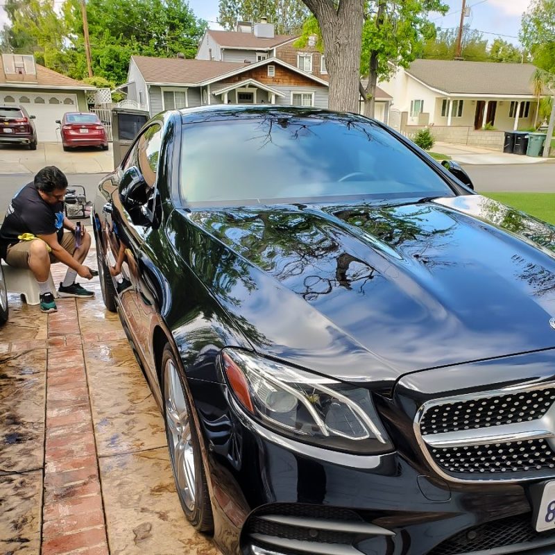 MobileWash detailer being the nearest car wash, doing a tire dressing on a Benz, for a car cleaning and quality auto detail.